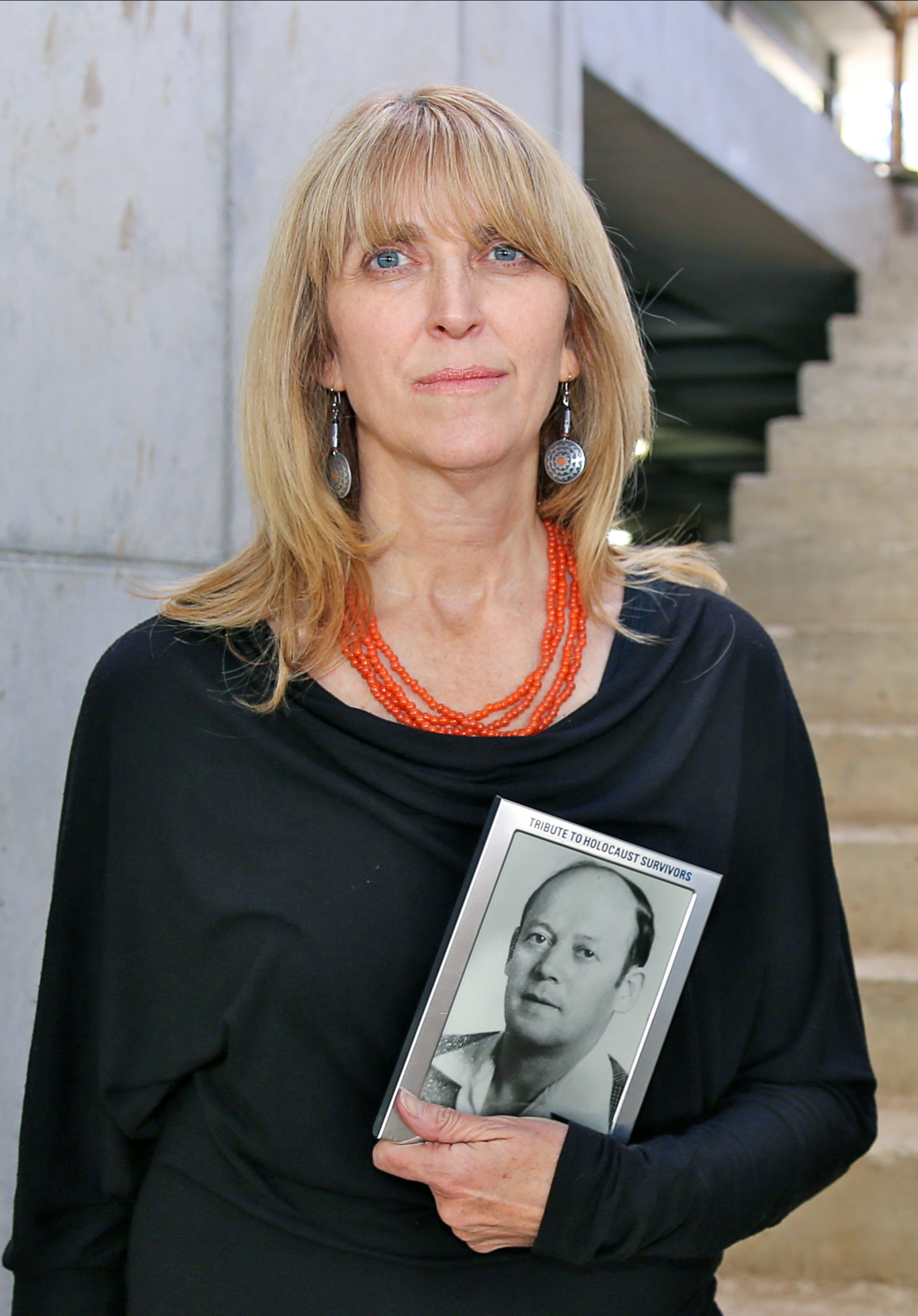 Tali Nates, Director, Johannesburg Holocaust & Genocide Centre, with a photo of her father. Johannesburg, South Africa @Jono David (vColorFramed) copy-2 Kopie